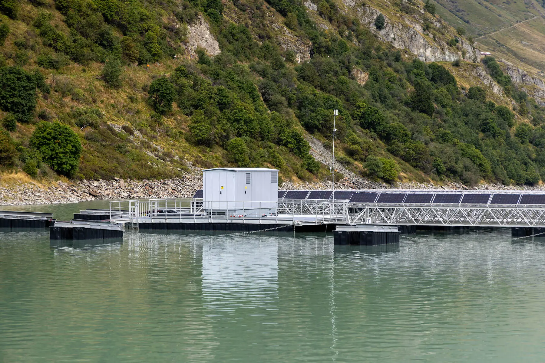 Floating solar panels on a calm lake.