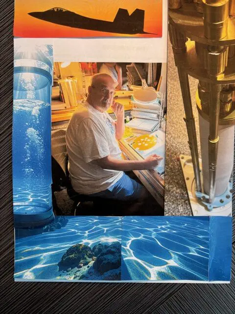 Man sitting and reading near a window with ocean-themed decor.