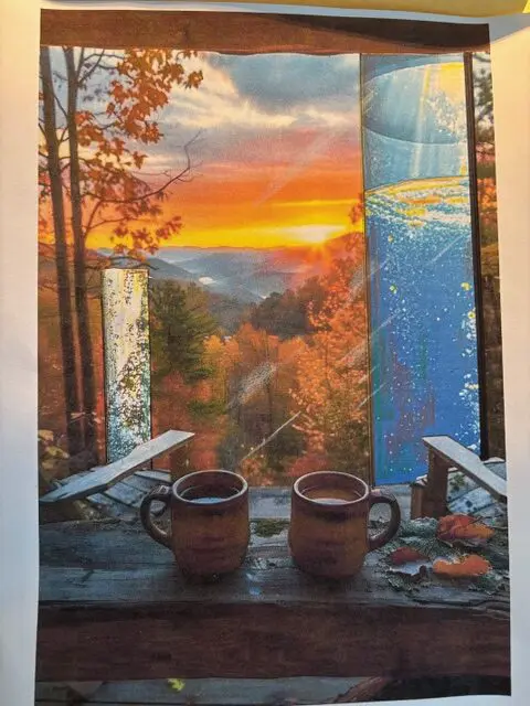 Sunset view with two coffee mugs on a porch surrounded by autumn trees.